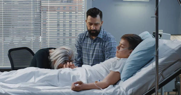 Teenager boy lying in hospital