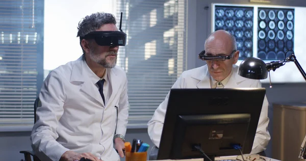 Doctors watching screen using virtual reality headset