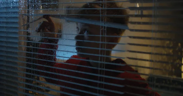 Boy watching storm through window — Stock Photo, Image