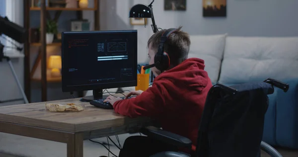 Gehandicapte Boy Hacking op zijn computer — Stockfoto