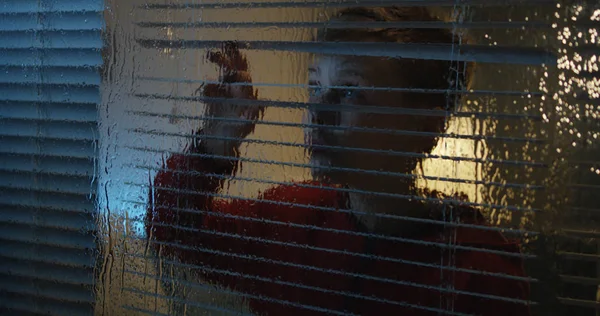 Boy watching storm through window — Stock Photo, Image