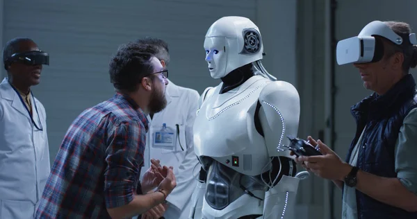 Scientist testing robot with gestures