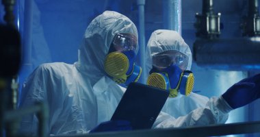 Hazmat giysili bilim adamları bakım çalışmaları yürütüyor