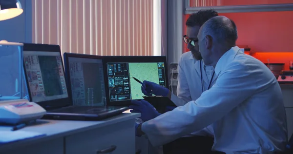 Scientists watching monitor and analyzing — Stock Photo, Image