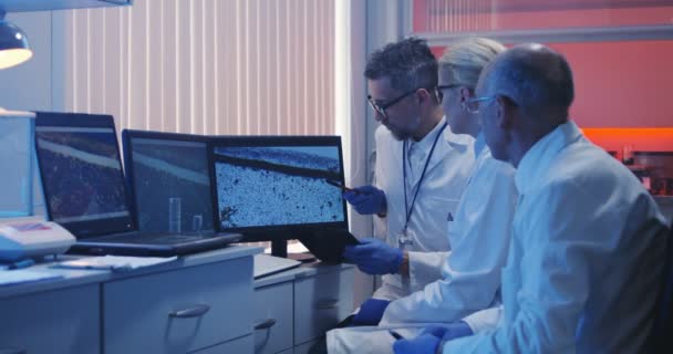 Scientists watching monitor and analyzing — Stock Video