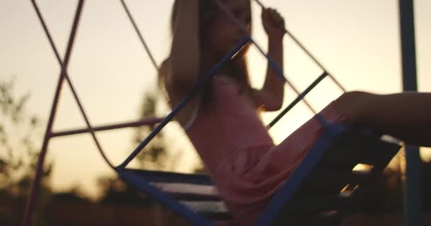 Swinging girl in playground — Stock Video