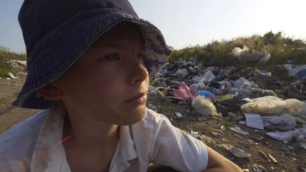 Annoyed beggar boy in dump — Stock Photo, Image