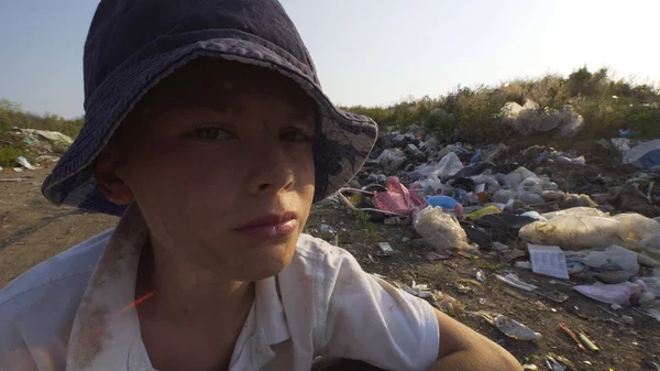 Annoyed beggar boy in dump — Stock Photo, Image