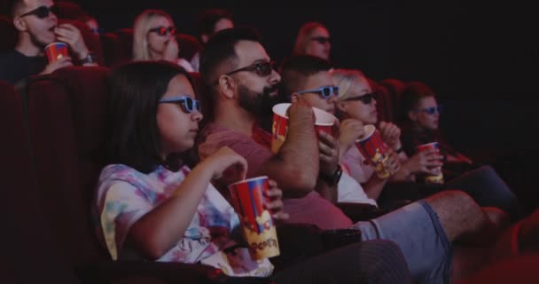 Familie eten popcorn in de bioscoop — Stockvideo