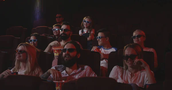 Moviegoers watching comedy movie in cinema — Stock Photo, Image