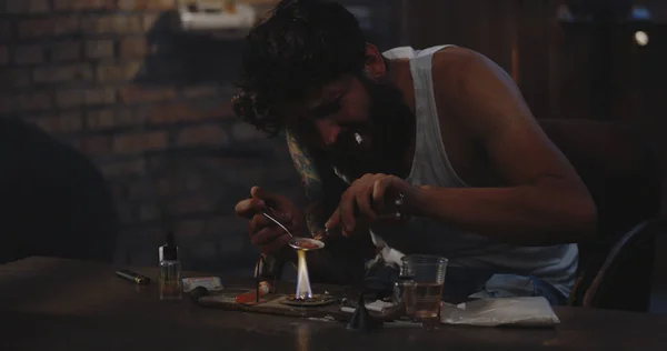 Hombre calentando droga en una cuchara — Foto de Stock