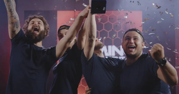 Gaming tournament team celebrating their victory