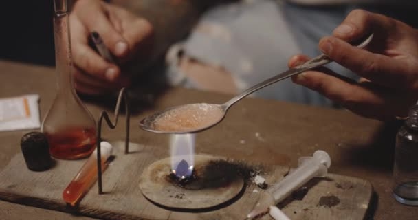 Man heating drug in a spoon — Stock Video