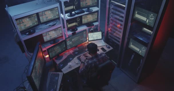 Хакер с помощью компьютера с несколькими мониторами — стоковое видео