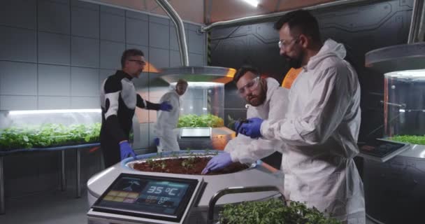 Scientists examining seedlings on Mars base — Stock Video