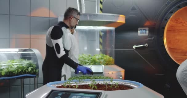 Scientist planting seedlings on Martian base — Stock Video