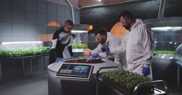 Scientists examining seedlings on Mars base — Stock Video