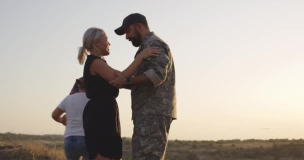 Soldato che abbraccia sua moglie e sua figlia — Video Stock