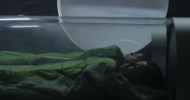 Astronauts sleeping in glass capsules — Stok Video