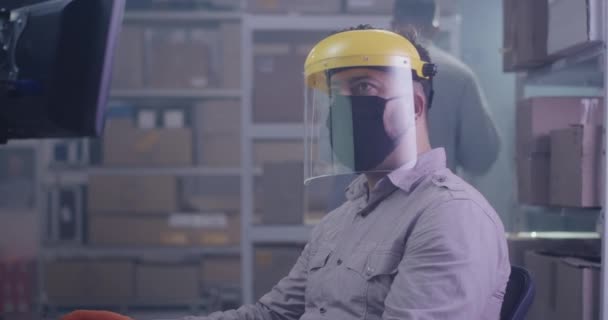 Man wearing protective gear in warehouse — Stock Video