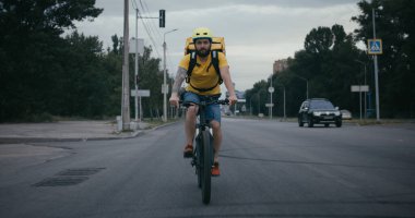 Bicycle messenger smiling at camera clipart