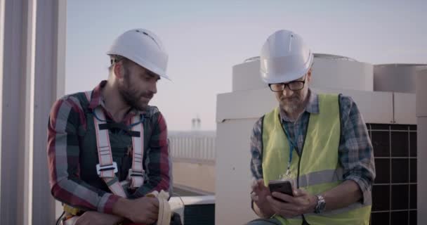 Ingenjörer som har en paus på ett mobiltorn — Stockvideo