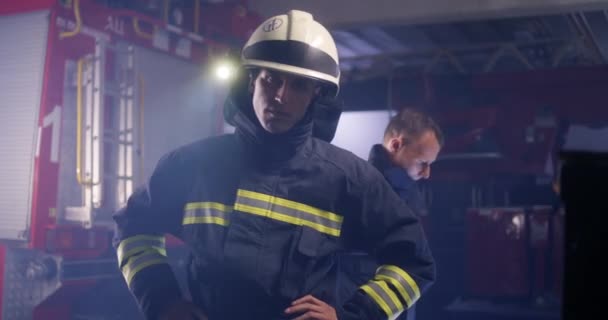 Серьезный пожарный смотрит в камеру — стоковое видео