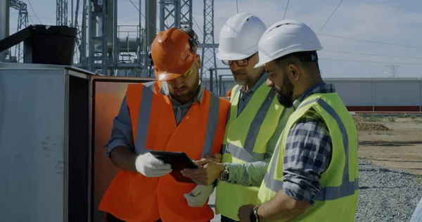 Engineer showing power transformer to inspectors