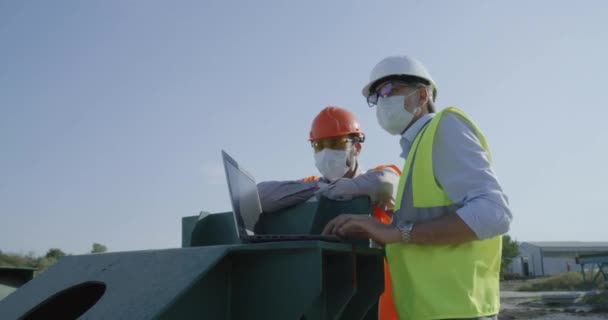 建設現場でラップトップを使用してマスクのエンジニア — ストック動画