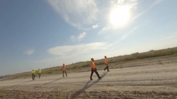 Workers walking on road near windmill — Stock Video