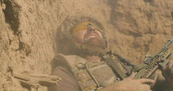 Scared fighter hiding in trench during war — Stock Photo, Image