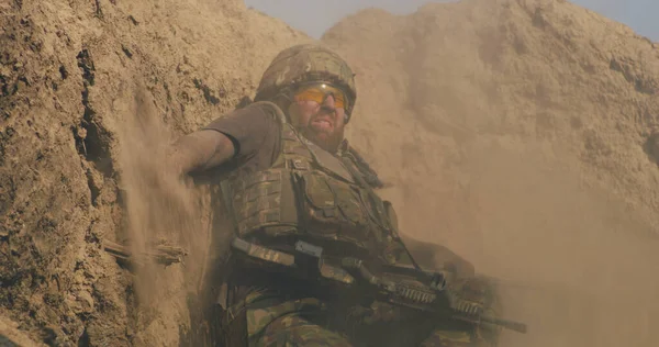 Scared fighter hiding in trench during war — Stock Photo, Image