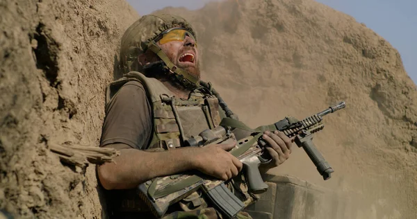 Scared soldier firing gun in air — Stock Photo, Image