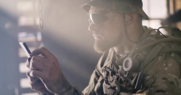 Soldier using smartphone on base — Stock Video