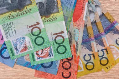 Colorful australian dollar banknotes close up on table clipart