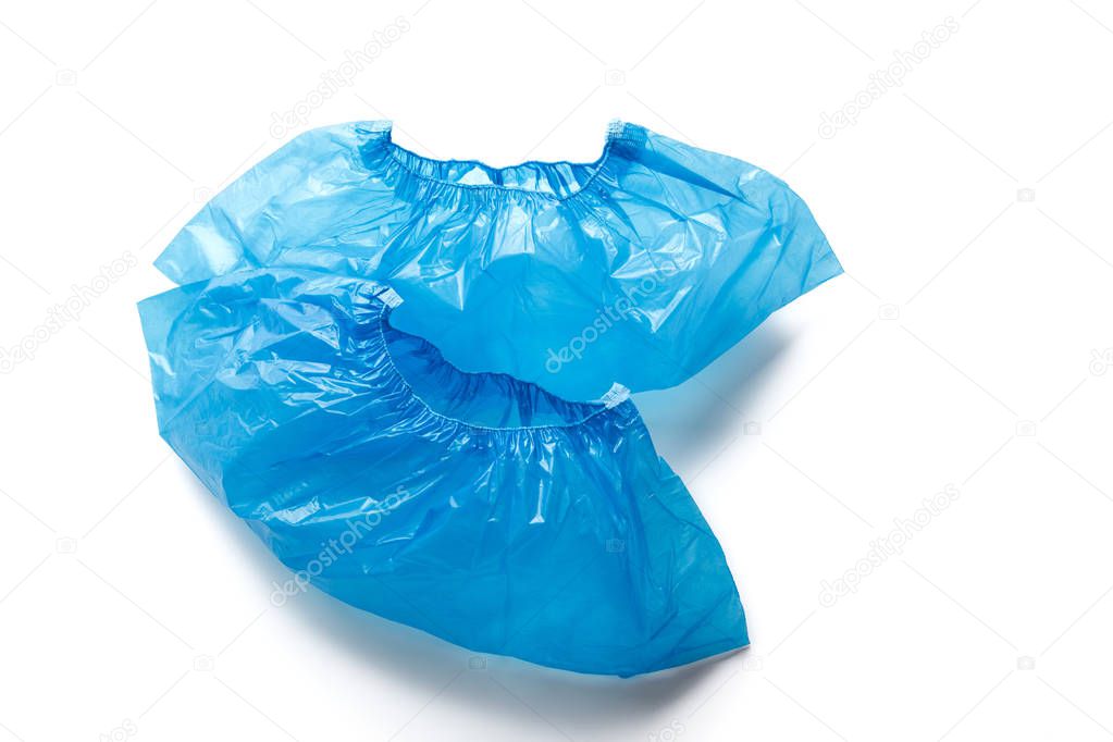 Two blue medical shoe covers, overshoes isolated on white background. Shoe covers for the feet. bahily. hygiene and cleanliness in medical institutions