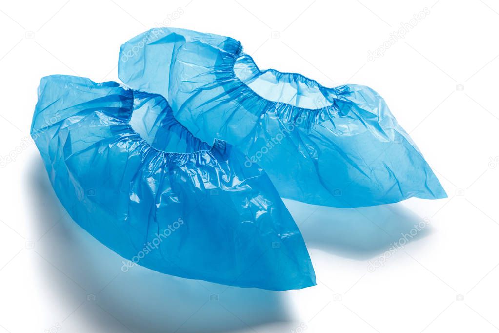 Two blue medical shoe covers, overshoes isolated on white background. Shoe covers for the feet. bahily. hygiene and cleanliness in medical institutions
