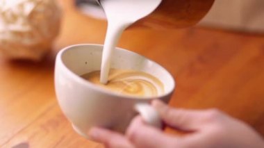 Barista süt bir kahve - cappuccino latte sanat yapma üzerine çizer. Barista Cafe latte sanat, kalp şekli yapma.