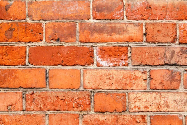 Vecchio mattone rosso sfondo parete irregolare. Close-Up di un vecchio muro di mattoni esterni, sfondo grunge Immagine Stock