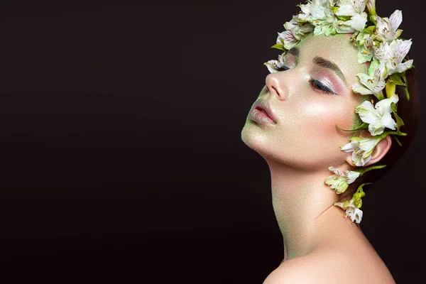 Beautiful woman portrait with flowers on head on black background