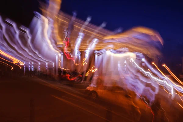 blurred lighhts from city lantern, car headlights and garlands of advertising signs