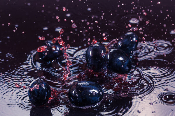 Beautiful splashes a clean water and fresh fruit. Clean grape berry with drops