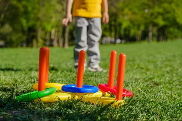 Ring throw summer game on a green lawn in the sun made of plastic