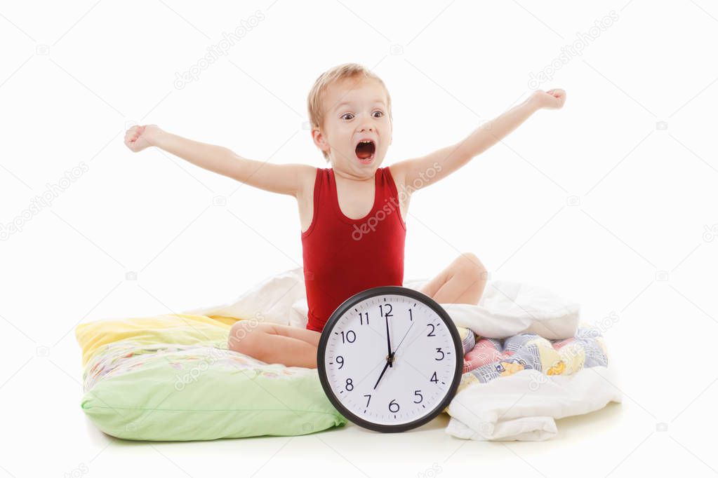 Small boy with alarm clock in the bed , wake up concept