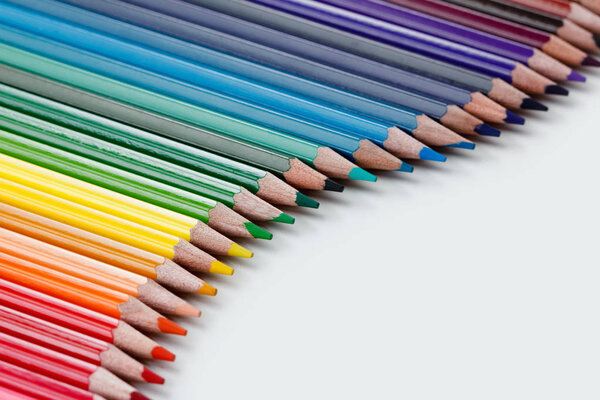 Group of colorful vibrant colored pencils on white background