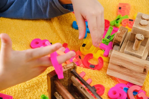 カラフルな文字と遊ぶ赤ちゃんの小さな手 教育コンセプト — ストック写真