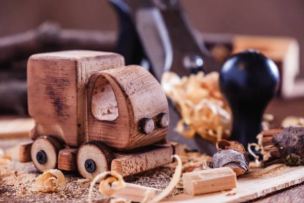 Wooden toy truck van car on the carpentry workbench. Hobby diy crafts, making toys