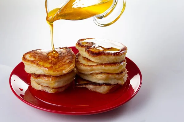 Honey syrup on pancake, delicious dessert food on white,  sweet. — Stock Photo, Image