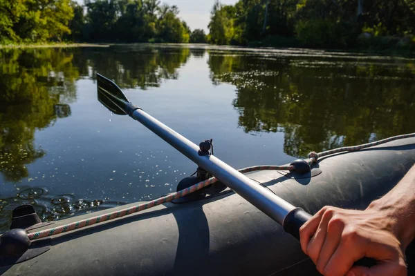 Rubber boat, hunter fisherman man's hand holding paddle — Stock Photo, Image