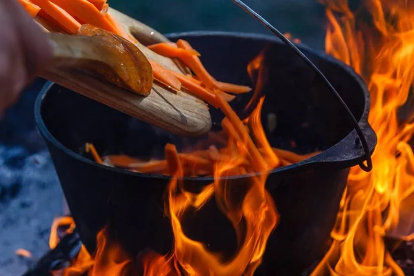 Bowler cooking food bonfire cauldron,  campfire firewood. — Stock Photo, Image